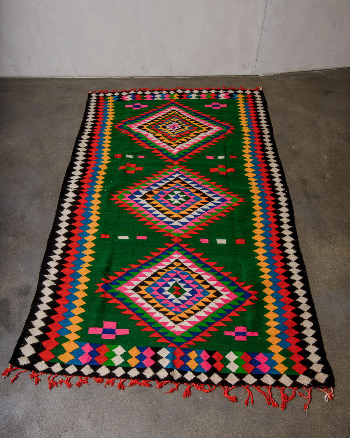 Colorful geometric patterned rug on a concrete floor